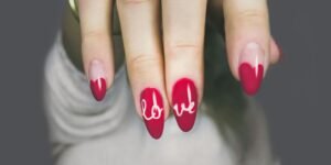 selective focus photography of woman's pink manicure