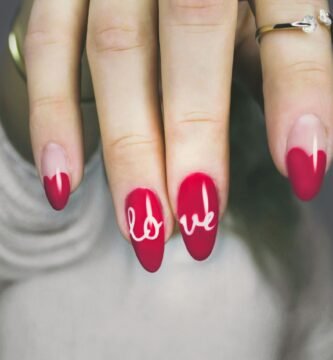 selective focus photography of woman's pink manicure